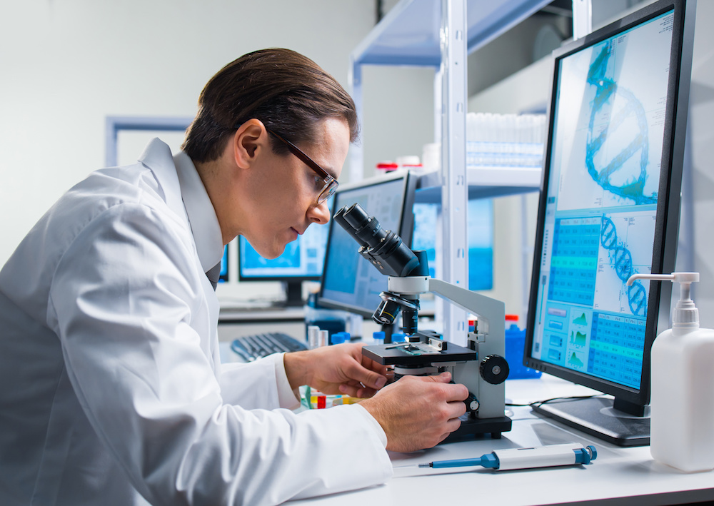 R&D, science, man looking in microscope