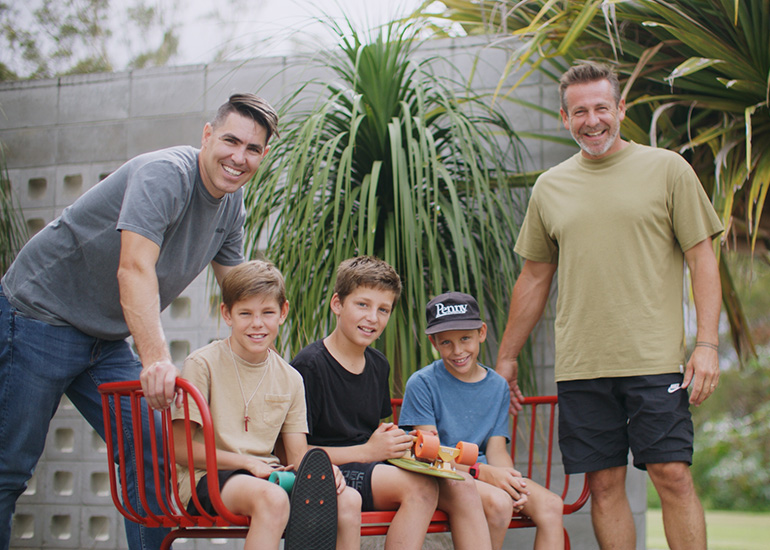 Penny Skateboards founder Ben Mackay with General Manager Nathan Reid and group of kids