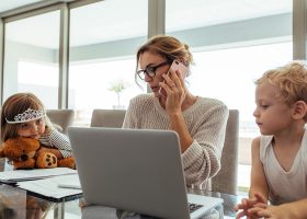 working mother at dining table with children