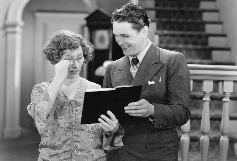 Old Hollywood photo of couple looking at a book