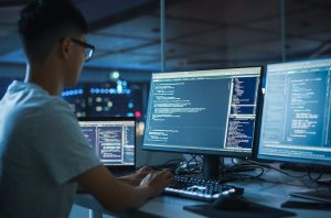 Working on Desktop Computer. Programmers Typing Code, Creating Modern Software, e-Commerce App Design, e-Business Programming.