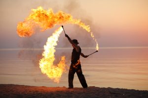 fire juggler on the beach