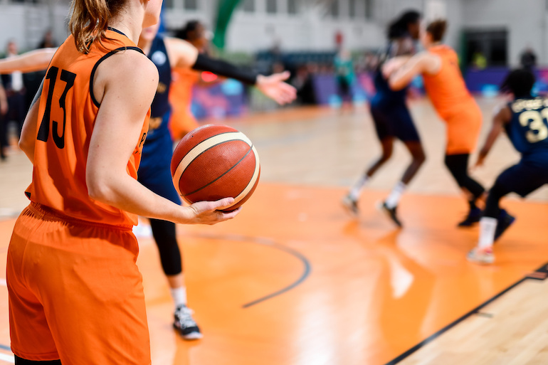 Woman, basketball match.