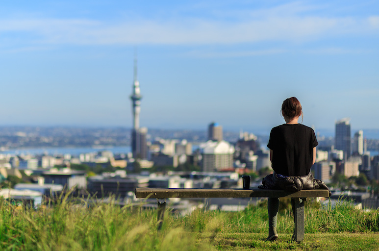Woman with views of Auckland city